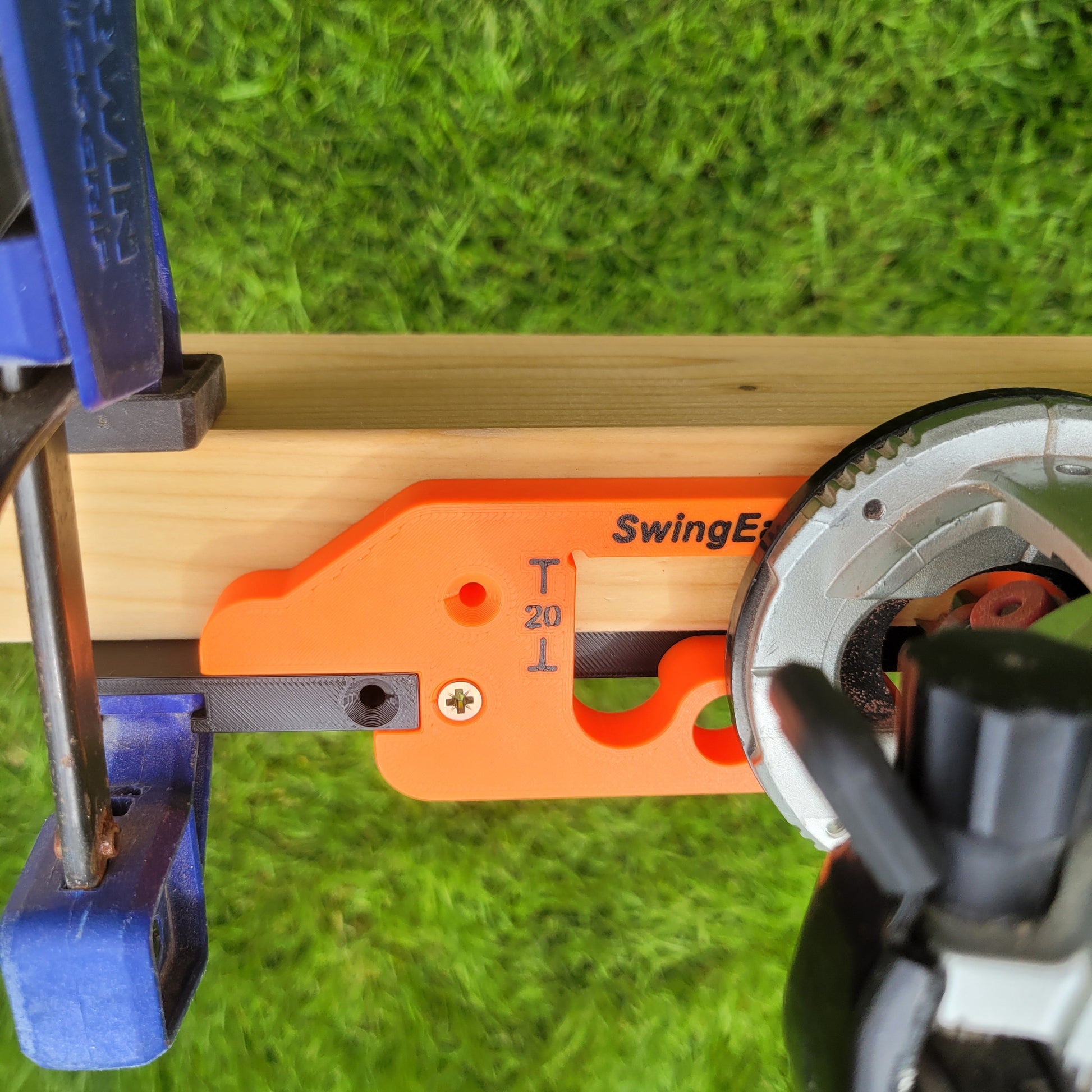 A black and orange Hinge Jig being used with a cordless router